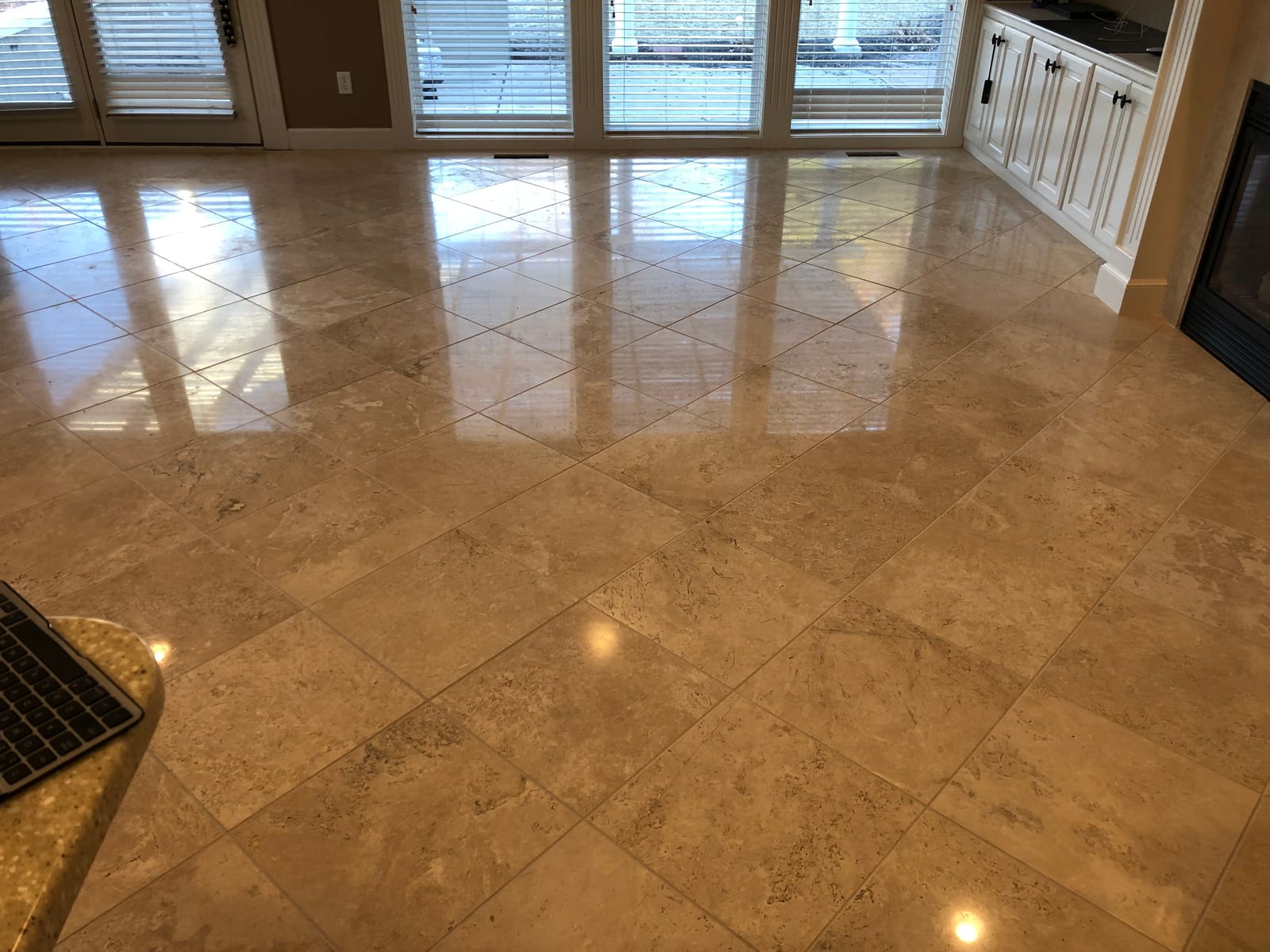 Travertine floor after honing and polishing, with window light reflecting off it