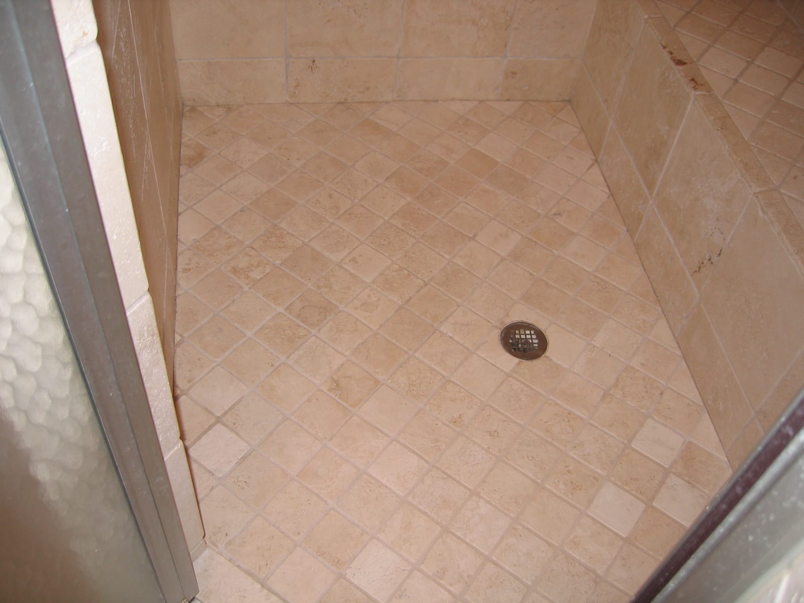 Same travertine shower after cleaning and sealing